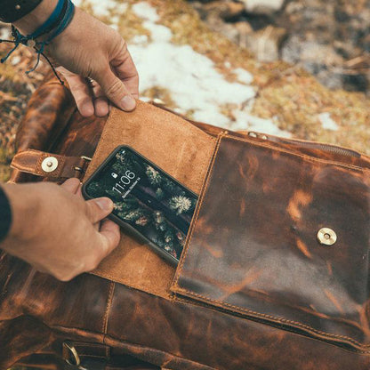 The Kobuk Men's Leather Backpack Roll Top Rucksack For Laptops Antique Brown Phone Front