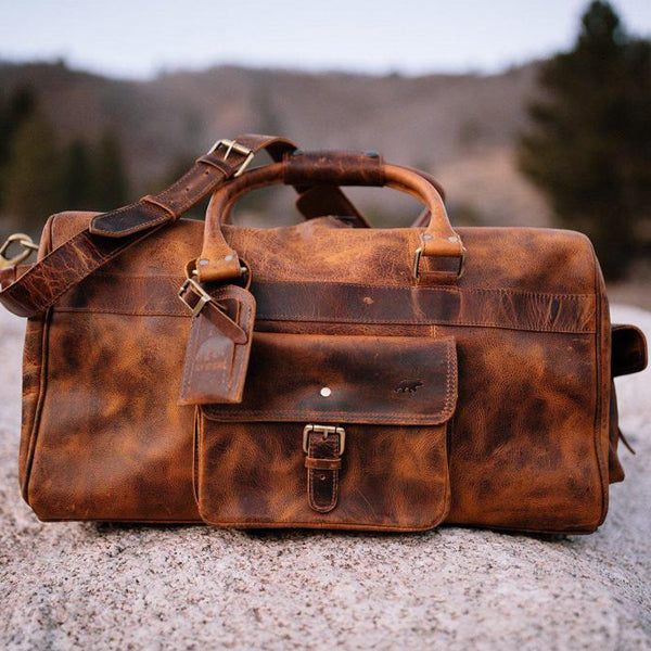 Men's Buffalo Leather Duffel Bag - Weekend Bag for Travel front view on rock